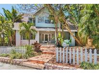 Charming two-story home features a welcoming front entrance and lush tropical landscaping at 532 Beach Ne Dr, St Petersburg, FL 33701