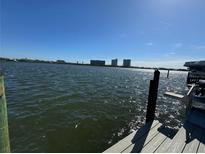 Relaxing waterfront view with a dock and distant buildings at 7827 9Th S Ave, St Petersburg, FL 33707