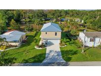 Two-story house with metal roof and waterfront lot at 6435 Finance Ave, Weeki Wachee, FL 34607