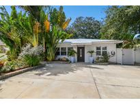 Bright house with tropical landscaping and a spacious driveway at 1906 2Nd St, Indian Rocks Beach, FL 33785