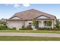 One-story home with stone accents and landscaped yard at 20876 Drake Elm Dr, Land O Lakes, FL 34638