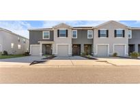 Three-unit townhome building with two-car garages at 1955 Hovenweep Rd, Wesley Chapel, FL 33543