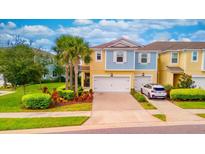 Two-story townhome with a two-car garage, nicely landscaped at 2001 Palm Key Ave, Oldsmar, FL 34677