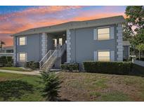 Two-story building exterior at sunset at 12049 Hoosier Ct # 202, Hudson, FL 34667