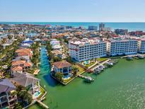 Beautiful aerial view of waterfront community with private boat slips and ocean views in the background at 17745 Gulf Blvd # 604, Redington Shores, FL 33708