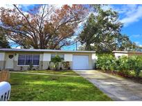 Cute ranch home with a well-maintained lawn and a spacious driveway at 9064 93Rd St, Seminole, FL 33777