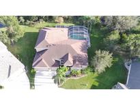 Expansive aerial view of a private home showcasing a screened pool, mature trees, and pristine landscaping at 10411 Riverburn Dr, Tampa, FL 33647