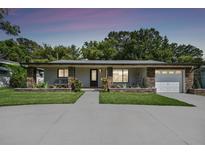 Modern house with stone accents and a two-car garage at 2115 Belmar Dr, Belleair Bluffs, FL 33770