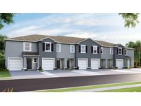 Modern gray townhome with two-car garage at 467 Mangrove Shade Cir, Apollo Beach, FL 33572