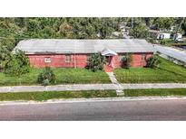 Aerial view of a brick home with a spacious yard and street parking at 3420 E 21St Ave, Tampa, FL 33605