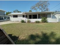 Single story home with covered patio and well-maintained lawn at 4310 Huntington Ne St, St Petersburg, FL 33703
