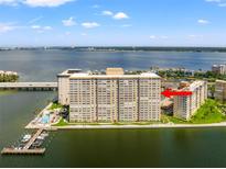 Aerial view of a waterfront high-rise building with a pool and marina at 5200 Brittany S Dr # 1202, St Petersburg, FL 33715