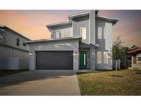 Modern two-story house with green door and gray exterior at 3119 W Cypress St, Tampa, FL 33607