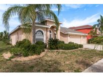 One-story house with a three-car garage and landscaped yard at 12923 Carlington Ln, Riverview, FL 33579