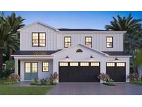 Modern two-story farmhouse style home with a three-car garage at 2919 W Elrod Ave, Tampa, FL 33611