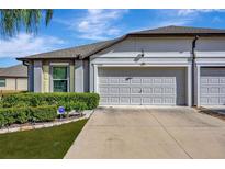 Two-car garage and well manicured landscaping at 13285 Crest Lake Dr, Hudson, FL 34669