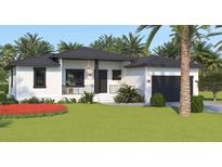 Single-story home with a modern design, dark roof, and attractive landscaping at 4026 Yucatan Cir, Port Charlotte, FL 33948