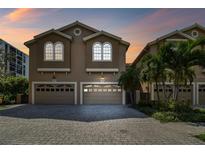 Two-story townhouse with double garage, showcasing attractive architecture at 348 Larboard Way, Clearwater, FL 33767