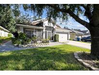 Charming single story home with landscaped yard and two-car garage at 31093 Satinleaf Run, Brooksville, FL 34602