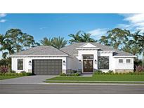 Single-story home with gray garage door and white exterior at 0 Dusky Warbler Rd, Weeki Wachee, FL 34614