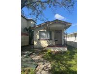 Cozy bungalow with front porch and small yard at 411 S Orleans Ave, Tampa, FL 33606
