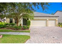 Beautiful two-story house with a three-car garage and manicured landscaping at 3320 Majestic View Dr, Lutz, FL 33558