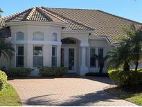 Beautiful home with tile roof, paver driveway, and lush landscaping at 11919 Royce Waterford Cir, Tampa, FL 33626