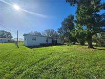 Mobile home with deck and large yard at 7902 Blair Dr, Wesley Chapel, FL 33544