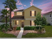 Two story home with landscaped yard and walkway at 8720 Savory Walk Dr, Land O Lakes, FL 34637