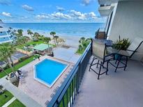 Enjoy stunning ocean views from this balcony overlooking a pool and sandy beach at 2618 Gulf Blvd # 407, Indian Rocks Beach, FL 33785