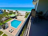 View of community pool and beach access from balcony at 2618 Gulf Blvd # 407, Indian Rocks Beach, FL 33785