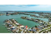 Stunning aerial view of waterfront homes with boat docks nestled in a tranquil community near the ocean at 7886 9Th S Ave, St Petersburg, FL 33707