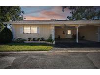 Front view of charming single story home with carport at 857 Cambridge Ct, Dunedin, FL 34698