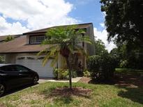 Two-story townhome with attached garage and landscaping at 13936 Clubhouse Cir # 13936, Tampa, FL 33618
