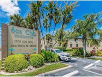 Sea Club Condominiums entrance with parking and lush landscaping at 19725 Gulf Blvd # 20, Indian Shores, FL 33785