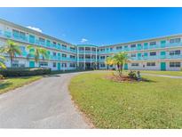 Exterior view of mid-century modern building with landscaping at 1950 59Th N Ave # 318, St Petersburg, FL 33714