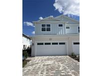 Charming two-story townhome with a paved driveway and attached two-car garage at 31895 Anchor Point Dr, Wesley Chapel, FL 33545