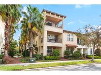 A beautiful three-story townhome featuring balconies and landscaped surroundings, perfect for comfortable living at 5902 Yeats Manor Dr, Tampa, FL 33616