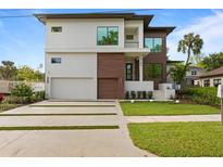 Modern house exterior with a two-car garage at 5104 W Evelyn Dr, Tampa, FL 33609