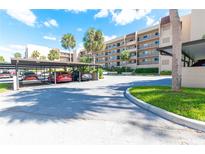 Covered parking area with additional open parking at 90 S Highland Ave # 1115, Tarpon Springs, FL 34689