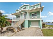 Two-story teal home with balcony and garage at 339 55Th Ave, St Pete Beach, FL 33706