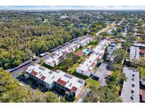 Aerial view of community showing building exteriors, pool, and parking at 2060 Marilyn St # 238, Clearwater, FL 33755