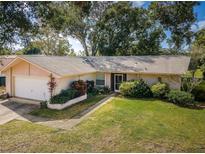 One-story house with a garage and spacious yard at 3231 Macgregor Dr, Palm Harbor, FL 34684