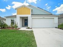 One-story home with a two-car garage and well-maintained lawn at 12730 Mangrove Forest Dr, Riverview, FL 33579