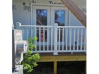 New home features a back patio with white railing and french doors at 5831 Michigan Ave, New Port Richey, FL 34652