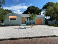 Newly renovated light teal home with orange garage door at 2658 48Th S St, Gulfport, FL 33711