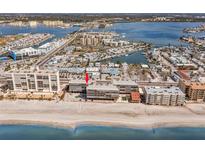 Aerial view showing condo building's beachfront location, adjacent to beach and other structures at 14900 Gulf Blvd # 410, Madeira Beach, FL 33708