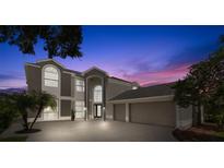 Two-story house with a three-car garage at dusk at 4915 Augusta Ave, Oldsmar, FL 34677