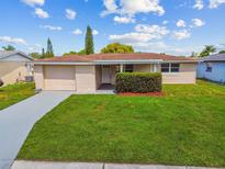 Single story home with a well-manicured lawn at 3525 Umber Rd, Holiday, FL 34691