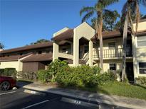 Two-story building exterior with brown roof and landscaping at 1100 E Bay Dr # 42, Largo, FL 33770